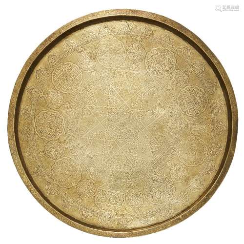 A large engraved brass tray and carved wood stand, Egypt or Syria, early 20th century, the round