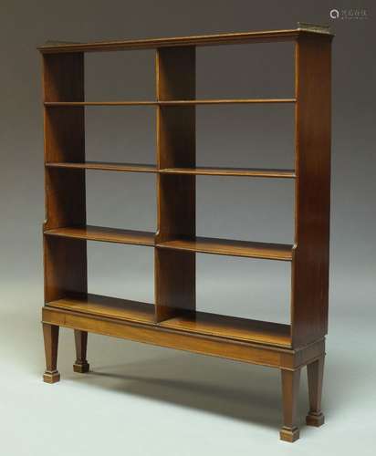 A George III style mahogany open book case, 20th Century, the top surmount with three quarter