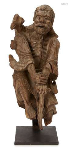 A Chinese carved wood figure of Li Tieguai, 18th century, carved leaning on his gnarled crutch, 41cm