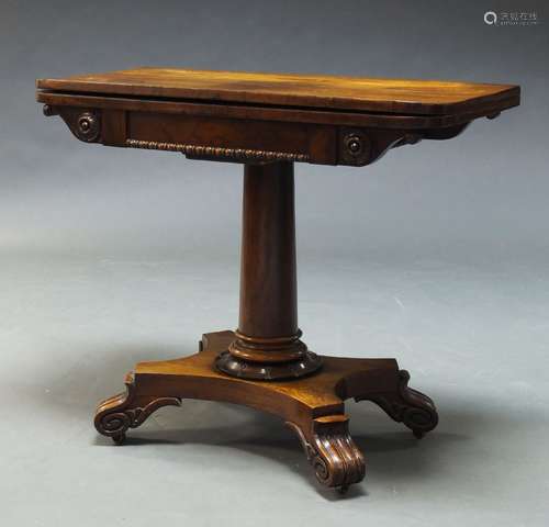 A William IV rosewood card table, the fold over top enclosing green baize lined playing surface,