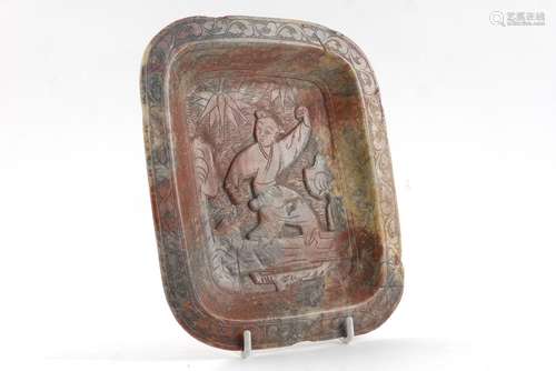 A Chinese rectangular soapstone dish, late 19th/early 20th century, carved with a figure of a