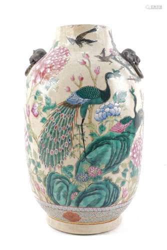 A Chinese porcelain vase, 20th century, with moulded mask and ring handles, decorated with peacock