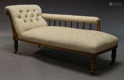 An Edwardian chaise longue, with scrolling end, the armrest with baluster turned supports, above