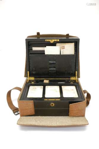 An Edwardian black leather cased writing box in a tan leather protective case, 30cm wide.150