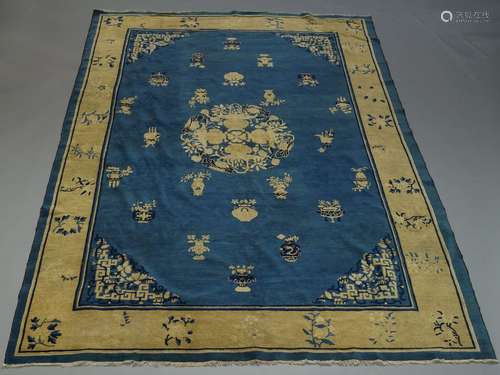 A Chinese rug, with central medallion composed of vases, the blue field decorated with antique