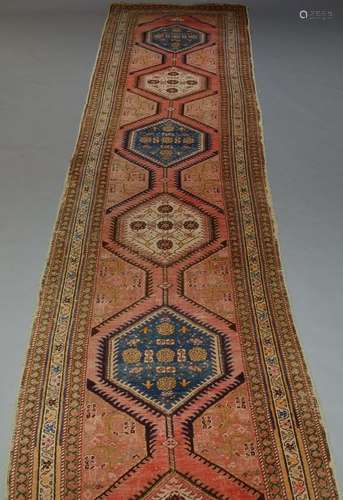 A Caucasian runner, early to mid 20th Century, with six medallions, enclosed by multiple borders,