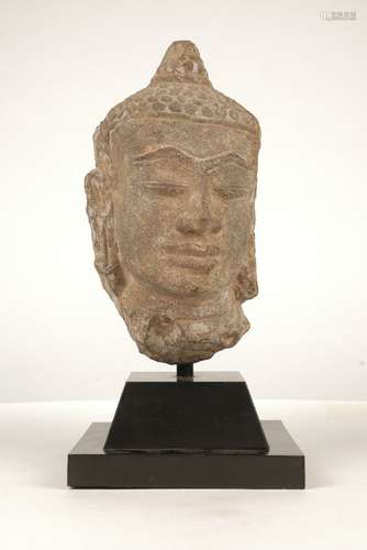 A Khamer style carved stone head of Buddha, early 20th century, 27cm high on a black painted