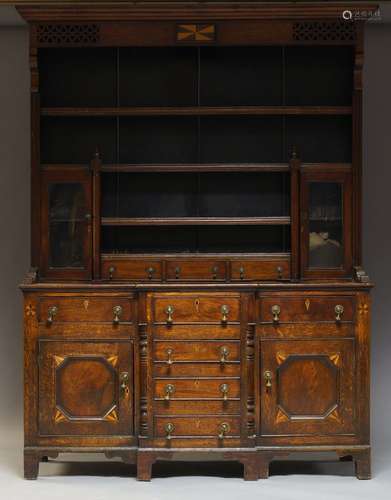 A Victorian oak and inlaid dresser, the plate rack with moulded cornice above three shelves, two