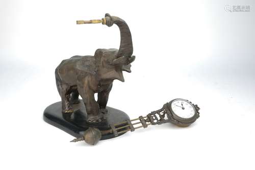 A spelter elephant mystery clock, late 19th/early 20th century, the elephant depicted standing on