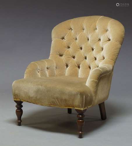 A Victorian button back nursing chair, upholstered in fawn colored velvet upholstery, raised on