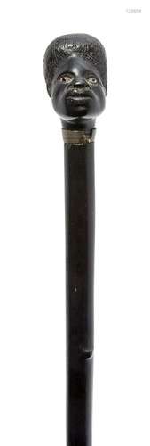 An ebony walking cane, late 19th/early 20th century, the finial in the form of an African man's