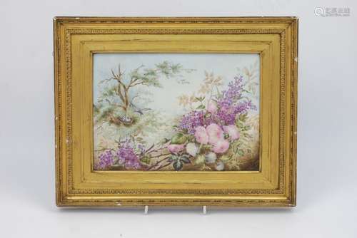 A porcelain plaque by Annie Symons, late 19th century, painted with a scene of birds feeding their