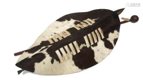 A Matabele zebra hide shield, 20th century, 97cm long, together with a spear, a knobkerrie club