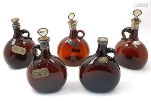 Five brown flask shaped white metal mounted decanters, 19th century, each bearing white metal wine