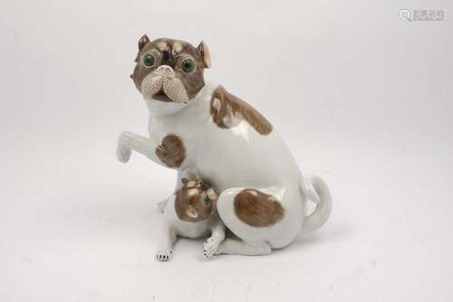 A Dresden porcelain figure of a female pug with puppy, 20th century, modelled seated with one paw