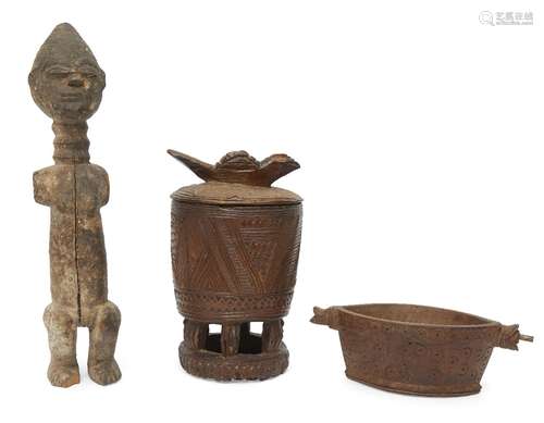 A tribal hardwood figure of a woman, Senufu, modelled standing with a conical head, with