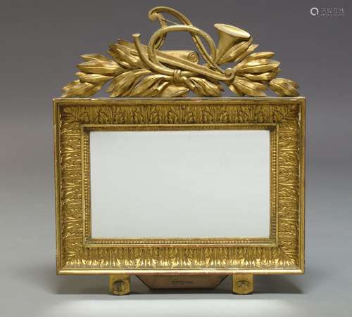 A gilt gesso rectangular wall mirror, late 19th Century, the pierced cresting with French horn, harp