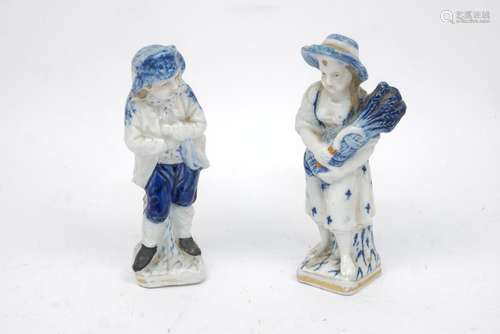 A pair of blue and white German porcelain figures of a boy and a girl from Schmeisser Porzellan