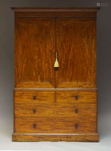 A Victorian mahogany linen press, the moulded cornice above two paneled cupboard doors, enclosing