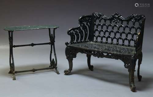 A Victorian black painted cast iron garden bench, with scrolling top rail above pierced backrest and