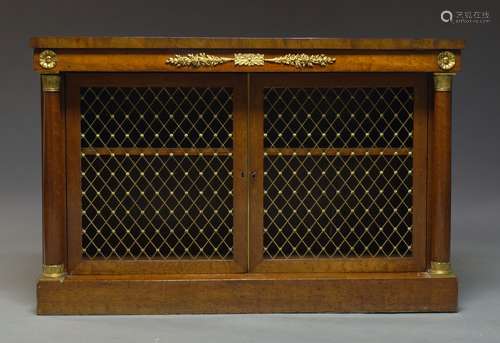 A French Empire mahogany and gilt metal mounted credenza, with two pierced brass lattice work doors,