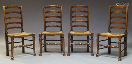 A set of four elm Lancashire ladderback chairs, early to mid 20th Century, with shaped