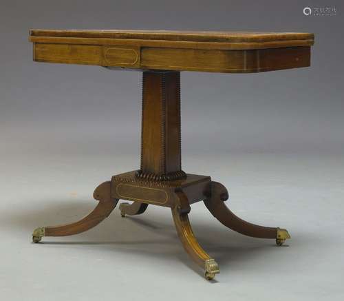 A Regency rosewood and brass inlaid, card table, the fold over top enclosing circular red baize