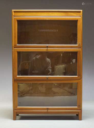 A Globe Wernicke style sectional bookcase, early 20th Century, with three glazed compartments on