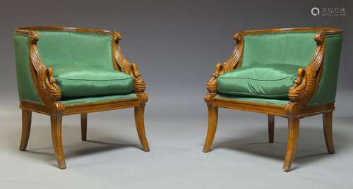 A pair of French Empire style walnut bergère armchairs, late 20th Century, the curved backs above