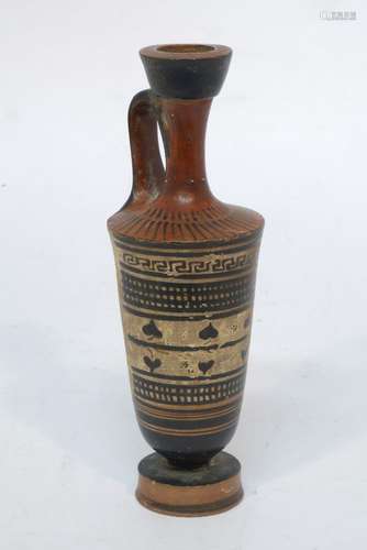 A Greek terracotta black-figure lekythos, 500-450 BCE, with a frontal geometric decorative