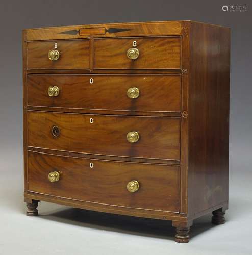 A Regency mahogany bow front chest, with two short over three long graduated drawers on later turned