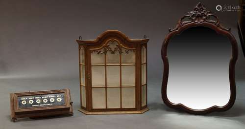 A Dutch taste wall mounted display cabinet, 20th century, with domed top and canted corners, with