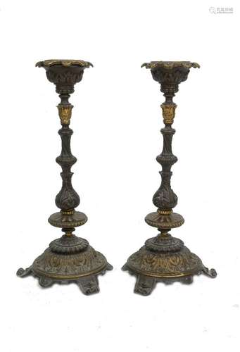 A pair of French bronze candlesticks, 19th century, the stems with heraldic shields, above writhen