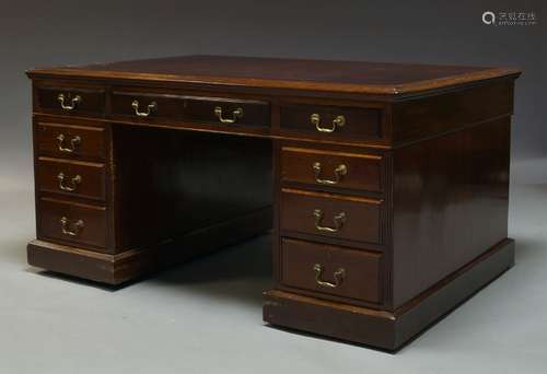 An Edwardian mahogany partner's desk, the rectangular top inset with burgundy leather writing