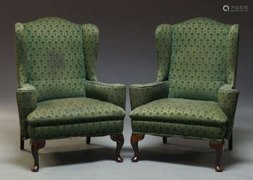 A pair of George II style wingback armchairs, late 20th Century, upholstered in green fabric, on