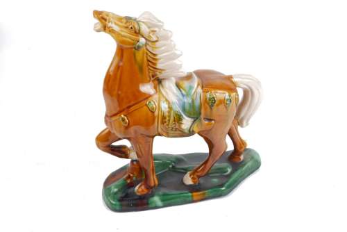 A Goebel Artis Orbis pottery horse, in the Chinese style, with a green glazed shaped base,
