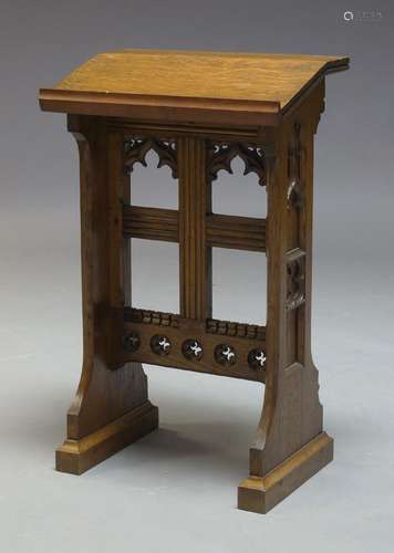 A Gothic oak prayer lectern, early to mid 20th century, the sloped top, raised on shaped end