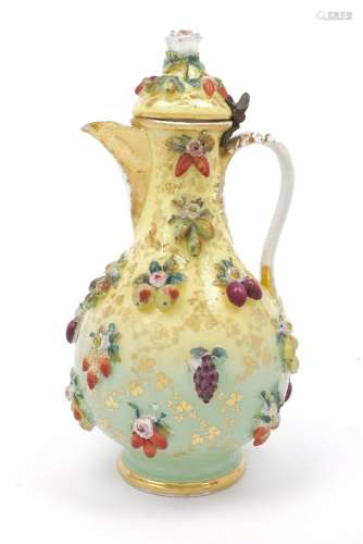 A Continental porcelain ewer, 19th century, with hinged lid, overall applied with fruit, flowers and