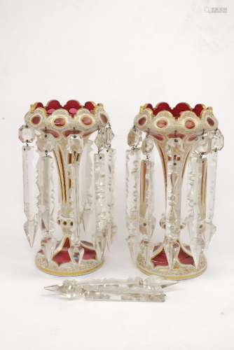 A pair of Bohemian cranberry glass lustres of flaring form, the bodies overlaid with milk white