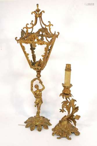 A gilt metal lamp, in the form of a female figure holding aloft a lantern, she standing on a foliate