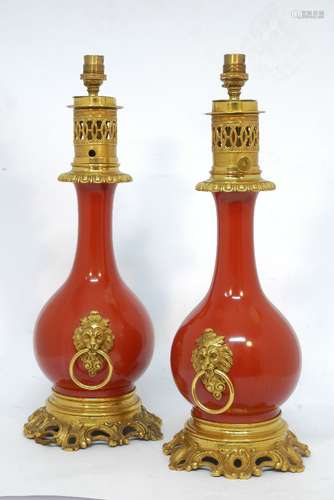 A pair of gilt bronze and red porcelain senumbra lamps, 19th century, later converted to