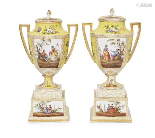 A pair of German porcelain twin handled urns and covers, late 19th/early 20th century, with square