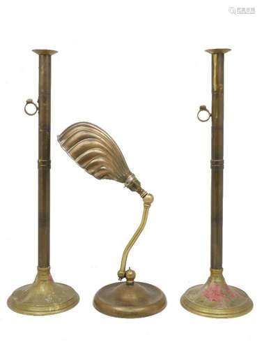 A pair of tall brass candlesticks, 19th century, with side ejectors, on domed circular bases, 60cm