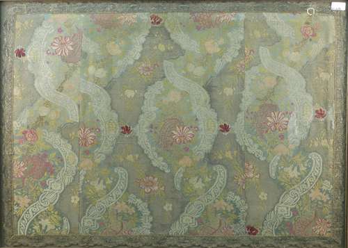 A large polychrome woven textile section, early 20th century, depicting a scrolling foliate pattern,