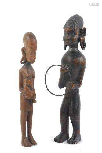 Two African hardwood figures, 20th century, to comprise a male figure with pendulous ears enriched