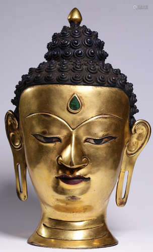 A GILT BRONZE EMBEDED TURQUOISE BUDDHA HEAD