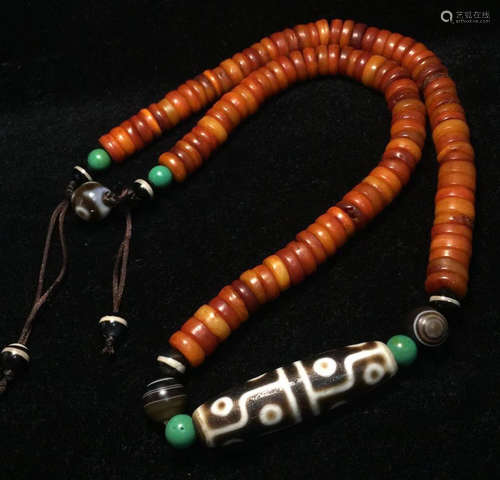 A TIBETAN 12 EYE PATTERN DZI STRING NECKLACE