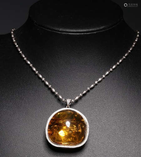 A SILVER PENDANT EMBEDED WITH AMBER