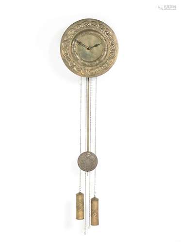 In the Manner of Margaret Gilmour (British, 1863-1942) An Arts & Crafts Repoussé Brass Wall Clock...