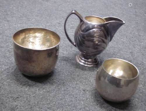 HECTOR MILLER: a silver cream jug and covered sugar bowl London 1998 With undulating linear decor...